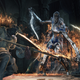 Two soldiers wearing armor fight a wraith in Dark Souls 3.